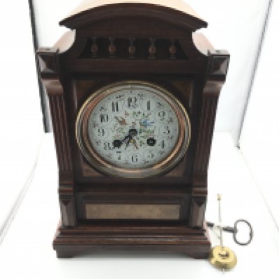 A Victorian mantle clock with pendulum. Winds and runs. 30cm tall by 19cm wide.