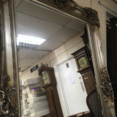 A large silver framed mirror with bevelled edge plate . 118 x184 cm .