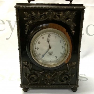 A small ebonized wood and silvered metal overlaid carraige clock, later movement (in need of restoration) 21cm x 14.5cm x 9.5cm