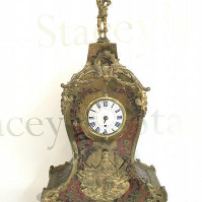 A tortoiseshell Boulle clock with brass decoration and Mars figure top, 38cm tall. This lot cannot be posted