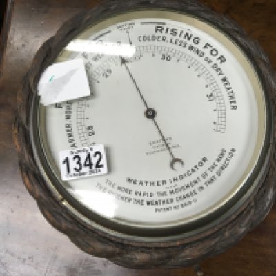 An oak cased wall barometer the dial with Boatman Southend silvered dial. Diameter 27cm