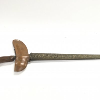 A vintage Indonesian Kris knife with wooden handle and brass scabbard. Wave blade, possibly Damascus steel. Blade length approximately 32cm Total length 50cm