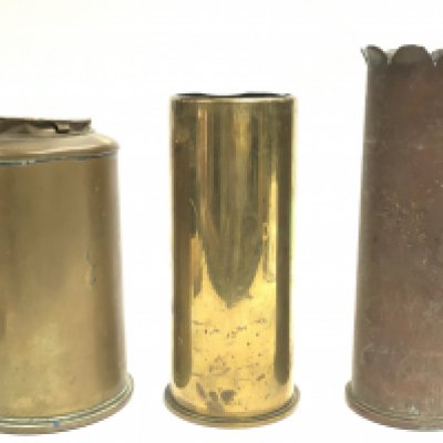 Three Trench Art Crafted Brass Vases. Comprising of A flower shape vase with Lancers Flags 20cm Tall, A 1917 Dated 18 Pounder Shell 17cm Tall and a Broad Arrow Marked 71/3rd Shell, 18cm Tall. All from the estate of a WW1/WW2 Collector. Postage category B