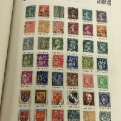 An international stamp album containing a good collection of World stamps including early 20th century world stamps cigarette card albums and other ephemera. NO RESERVE
