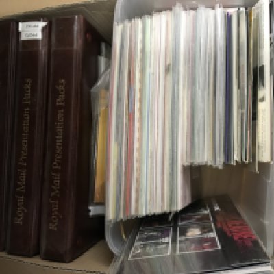 A box containing a large collection of presentation packs