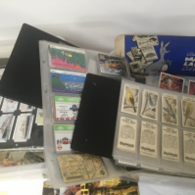 Two boxes containing an extensive collection of cigarette cards including Barratt & Co Players Poultry Phone cards tea Cards Vintage IDW topps cards and many others in albums and loose (2)