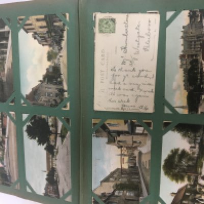 An Antique post card album containing a good selection of early 20th century cards and one other smaller album. (2)