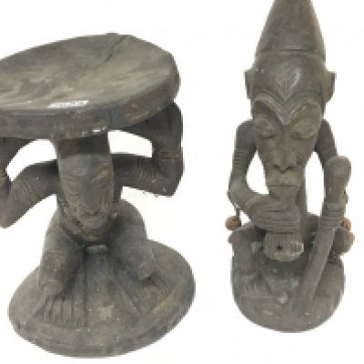 A carved hardwood African seat the circular top supported by a figure and one other African tribal carving (2) NO RESERVE