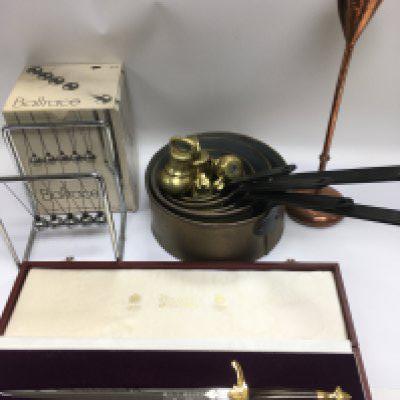 A collection of items comprising a set of brass weights, preserve pans, a Boxed Newton's cradle etc. Shipping category D. NO RESERVE