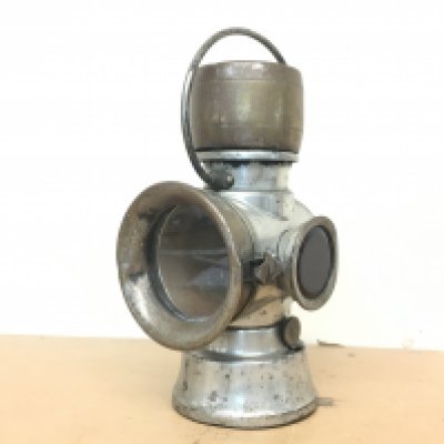 A vintage car lamp with burner by Joseph Lucas and red side lamp. This lot cannot be posted