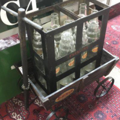 A small garage forecourt trolley for an Esso crate with eight Essolube bottles all with Esso labels. This lot cannot be posted