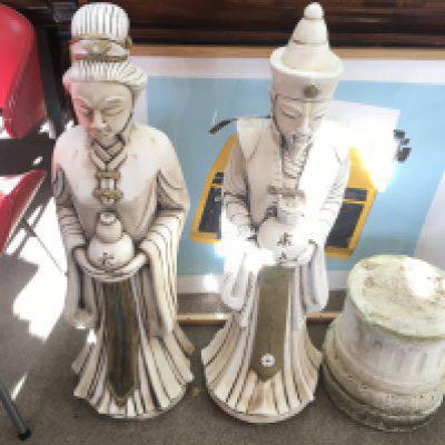 An oriental man and woman concrete garden statues. Approximately 3ft without bases. Postage D