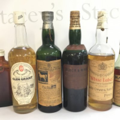 A collection of whiskeys including Glen Grant, White Horse, Black and White, White Label, Martell. Mixed levels . This lot cannot be posted