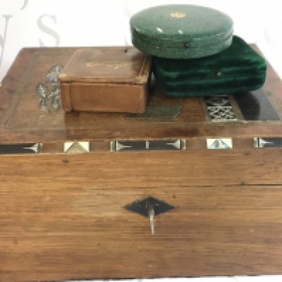 An inlaid wooden sewing box with studs. Postage category B