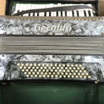 A vintage cased Geraldo accordion. Postage D