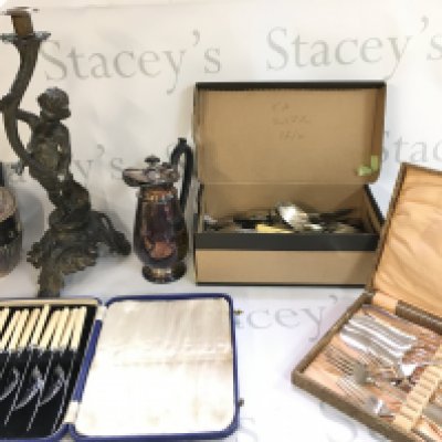 A Collection of silver plate including cutlery, a jug, teapot and a pewter candle stick figure. Postage category C