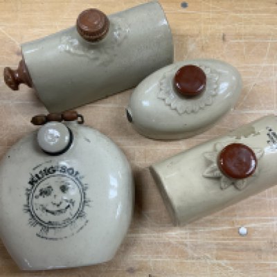 A collection of vintage stoneware foot warmers. (D)