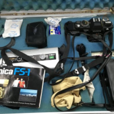 A cased Konica FS-1 camera with various accessories including a Yashica Electro 8 LD-6. Postage category C