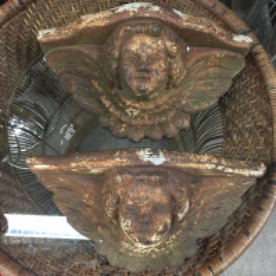 A pair of cherub cast iron wall planters, 34cm wide. This lot cannot be posted