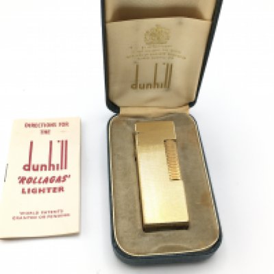 A vintage Dunhill gold tone lighter with case and paperwork.Postage B