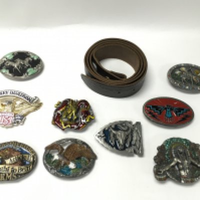 A collection of 9 belt buckles with a new leather belt. Postage B