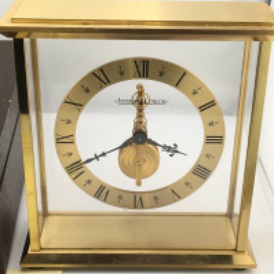 A Jaeger LeCoultre mantle clock with own fitted box. Winds and runs. 16cm wide and 17cm tall. Postage D