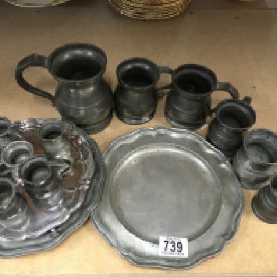 A collection of pewter tankards, two pewter trays and a silver plated dish