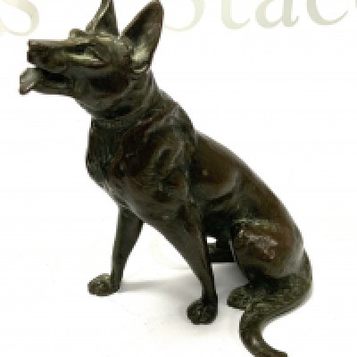 A bronze seated figure of an Alsatian signed L Carvin on the collar.