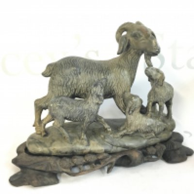A Chinese soapstone goat figure with a wooden base , 18cm tall. This lot cannot be posted