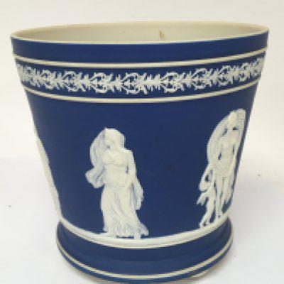 A late Victorian Jasper ware jardiniere decorated with classical figures on a blue ground with small bun feet no obvious damage height 19cm. NO RESERVE