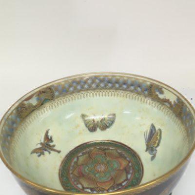 A Quality Wedgwood lustreware bowl decorated with butterflies and panels of oriental buildings. The centre of the bowl with an elaborate rose. On a Chinese hardwood stand bowl diameter 22cm bowl Hight 15cm