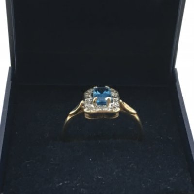 A 9 carat gold blue topaz and diamond shard set ring. n/o. Postage category A