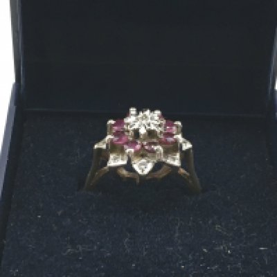 A 9 carat gold diamond and ruby ring, size K