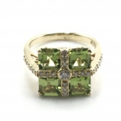 A 14ct yellow gold ring set with four square-cut peridots and RBC diamonds set in a cross pattern, with scroll design collet. Peridots 2.85ct approx, diamonds 0.45ct approx. Size N/O. Total weight 5.4g. Postage category a