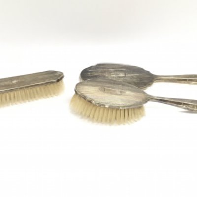 A Silver backed hand mirror and two matching brushes Birmingham hallmarks. This lot cannot be posted
