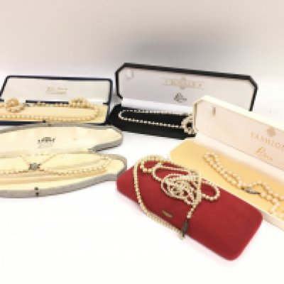 a collection of simulated pearl necklaces, postage category B