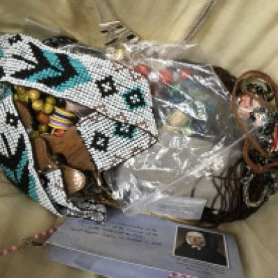 A basket of jewellery including necklaces, bracelets etc