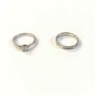 A beaver brooks platinum diamond set band and a diamond solitaire wedding ring. With a certificate for the diamond set band. Approx diamond weight of band 0.06cts, approx diamond weight of the solitaire 0.25cts. Approx weight 6.3grams.