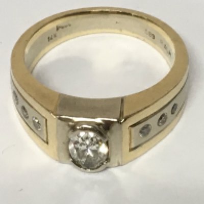 A Gents 14 carat gold watch set with a good size oval diamond flanked by small brilliant cut diamonds ring size V. Total weight 13g.