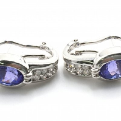 A certificated pair of 18ct white gold earrings set with oval tanzanites and RBC diamonds (G-H) with french style clips. Tanzanites 5.80ct, diamonds 0.36ct. Cert no WGI9624148292. 10.7g total weight postage category A
