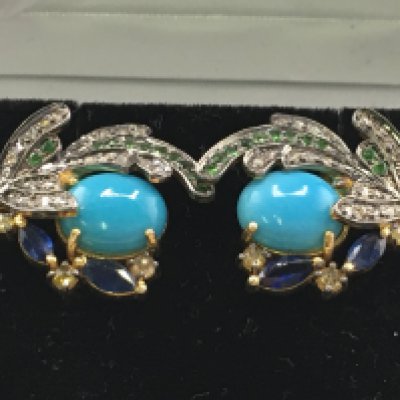 A pair of exotic bird of paradise earrings in silver gilt, set with cabochon turquoise, marquise-cut sapphires, round cut emeralds, rubies and diamonds. Turquoise 4.23ct. Sapphires 0.78ct. Emeralds 0.28ct. Diamonds 0.67ct. Postage category a