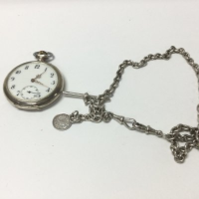 A silver hallmarked Albert chain with a silver pocket watch.