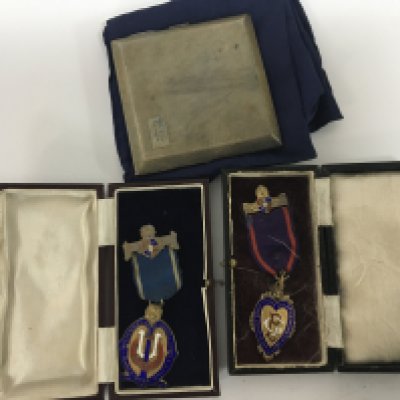 A silver cigarette box and two silver and enamel Oddfellow medals.(3)