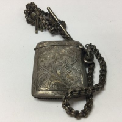 Silver Vesta case with Birmingham hallmarks attached to a silver Albert chain.