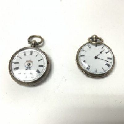 Two small silver pocket watches.