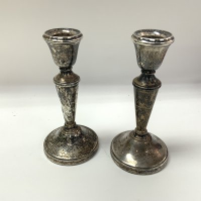 A pair of sterling silver candlesticks with Birmingham hallmarks. Approx height 14cm.