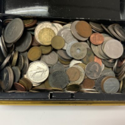 A tin of foreign coins.