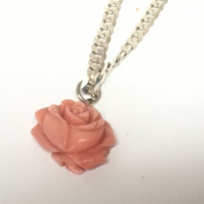 A silver necklace with carved coral pendant. Weight 22g. NO RESERVE