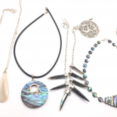 A collection of silver necklaces with polish stone pendants and a silver bracelet and pendant. Postage B