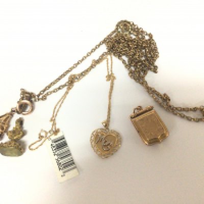 A gold plated antique long guard chain seal fobs and a modern gold heart shaped pendent with attached chain a Victorian locket and small pendent.